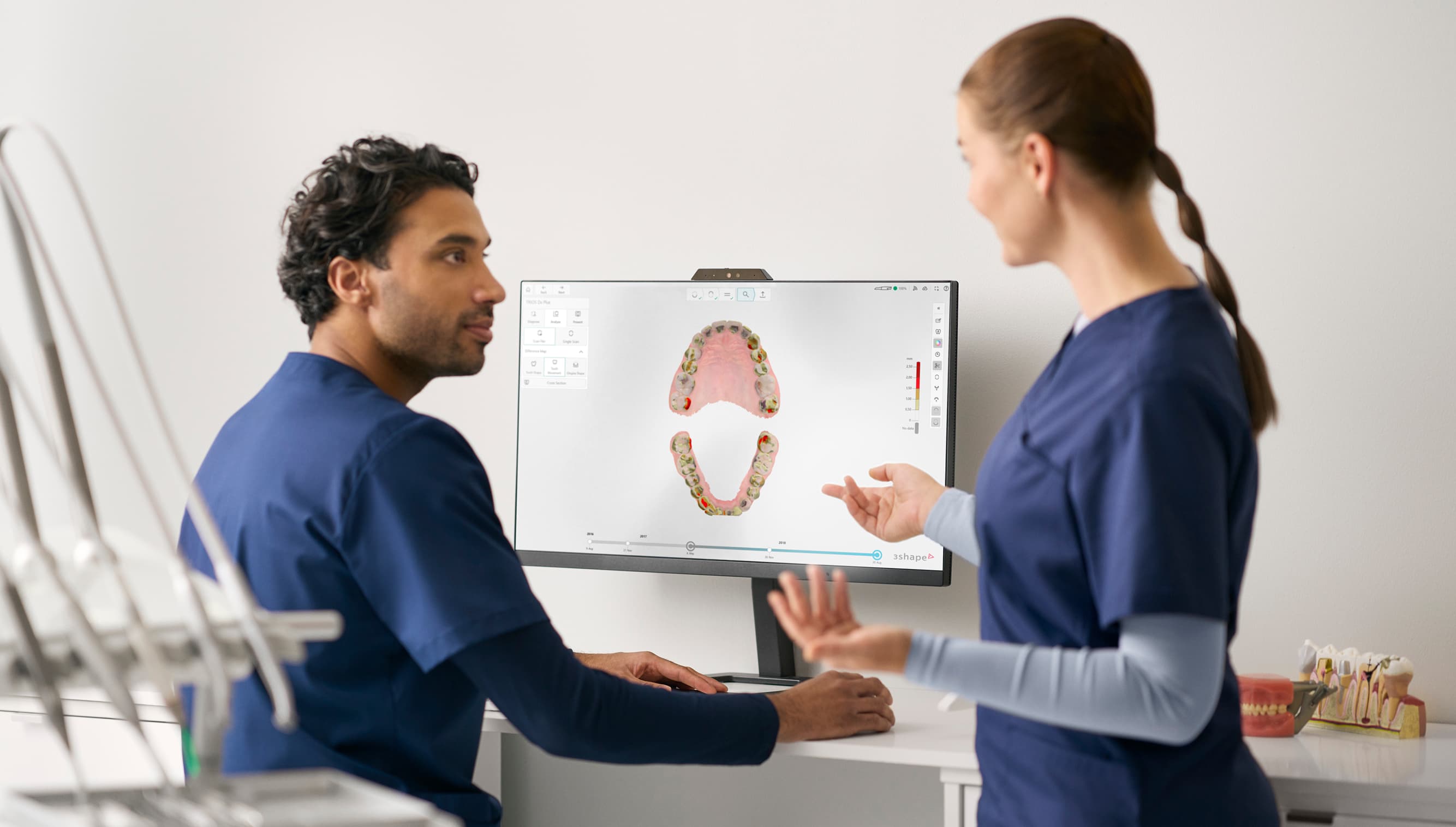 Two dentists reviewing DX Plus on a screen